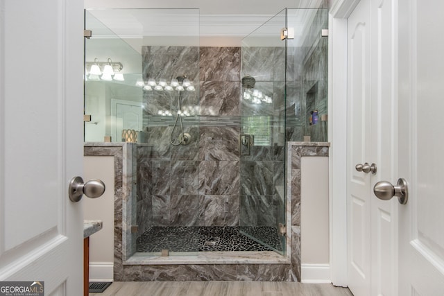 bathroom featuring crown molding, visible vents, and a stall shower