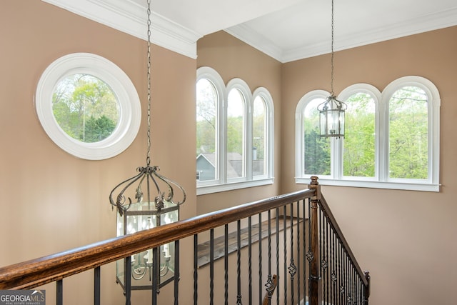 interior space featuring ornamental molding and a notable chandelier