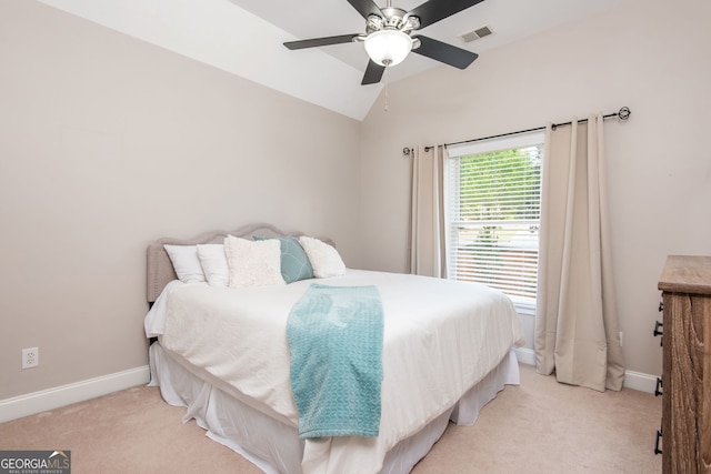 bedroom featuring lofted ceiling, baseboards, light carpet, visible vents, and ceiling fan