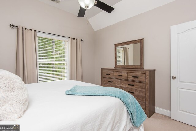 carpeted bedroom with ceiling fan, baseboards, and vaulted ceiling