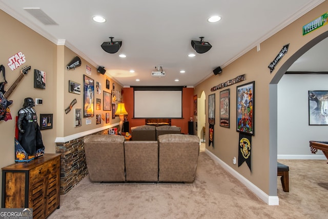 cinema room with visible vents, arched walkways, ornamental molding, carpet floors, and recessed lighting