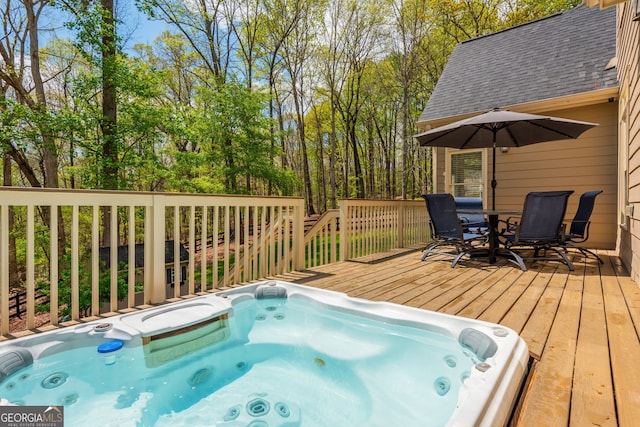 wooden terrace featuring outdoor dining area and hot tub deck surround