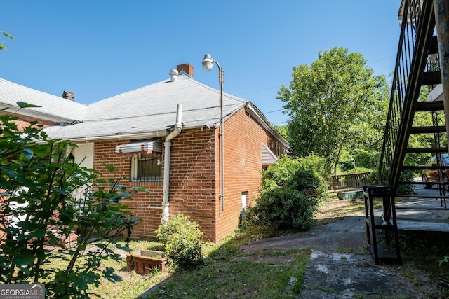 738 Liberty St, Macon, GA 31201 - view of side of home featuring brick siding and a shingled roof