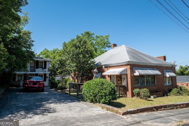 738 Liberty St, Macon, GA 31201 - view of front of house with brick siding, a chimney, and asphalt driveway