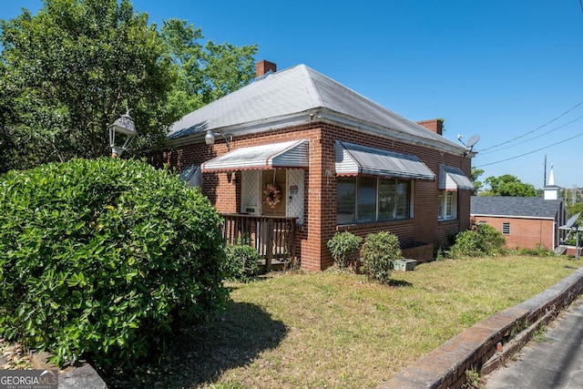 738 Liberty St, Macon, GA 31201 - view of front of property featuring a chimney, a front lawn, and brick siding