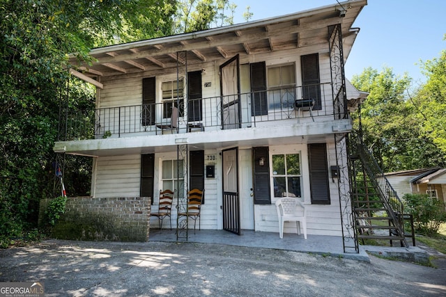738 Liberty St, Macon, GA 31201 - view of front of property with a balcony, stairs, and covered porch