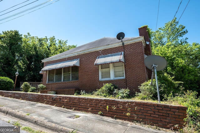 738 Liberty St, Macon, GA 31201 - view of property exterior with brick siding and a chimney
