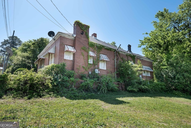 738 Liberty St, Macon, GA 31201 - view of side of property featuring brick siding, a yard, and a chimney