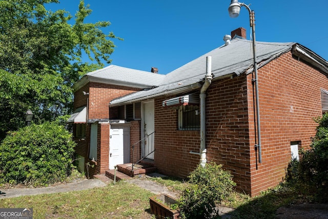 738 Liberty St, Macon, GA 31201 - rear view of property with brick siding, a chimney, and entry steps
