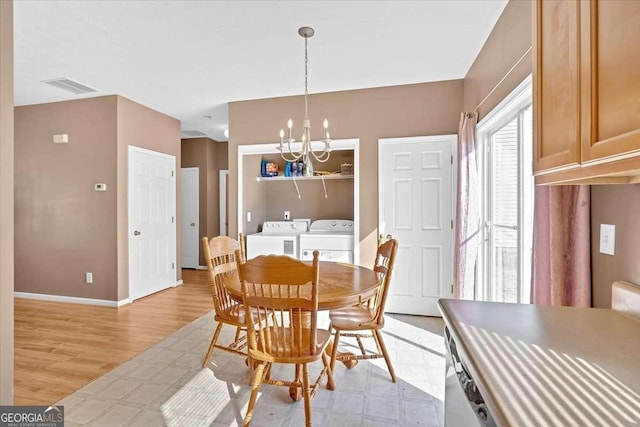 200 Arrowhead Ln, Canton, GA 30114 - dining area featuring visible vents, baseboards, washer and clothes dryer, a chandelier, and light wood-style flooring