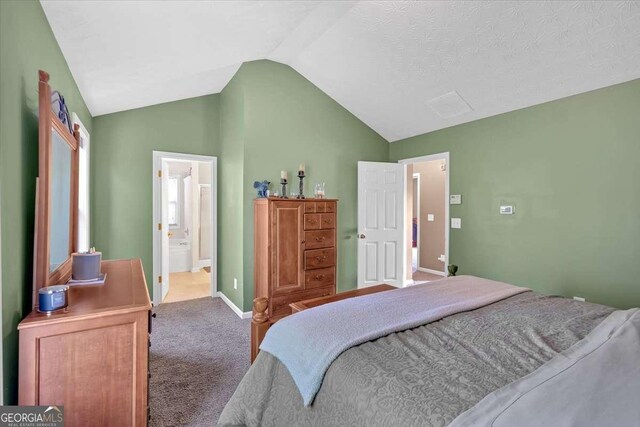 200 Arrowhead Ln, Canton, GA 30114 - carpeted bedroom with baseboards, ensuite bath, and vaulted ceiling
