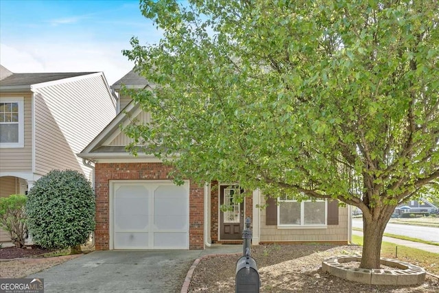 200 Arrowhead Ln, Canton, GA 30114 - view of property hidden behind natural elements featuring brick siding, an attached garage, and concrete driveway