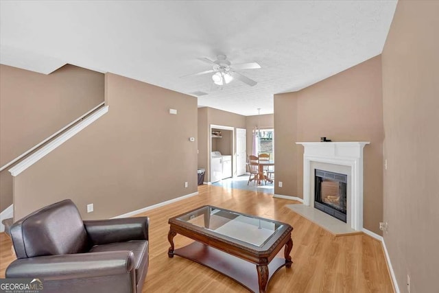 200 Arrowhead Ln, Canton, GA 30114 - living room featuring baseboards, independent washer and dryer, a ceiling fan, and wood finished floors
