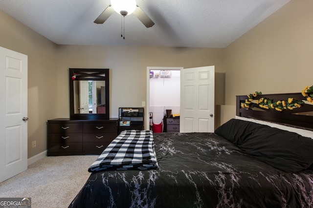 carpeted bedroom featuring baseboards and a ceiling fan