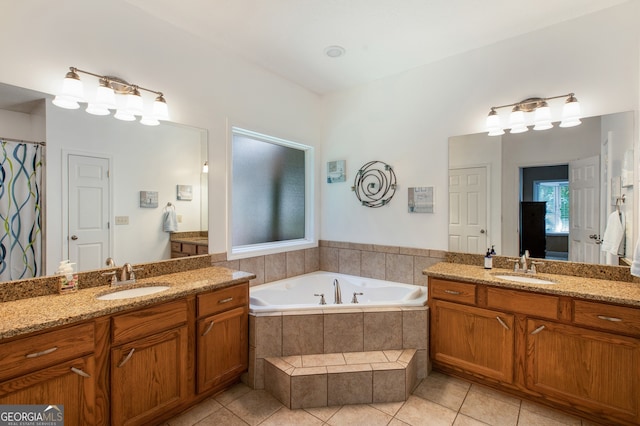 full bath featuring tile patterned flooring, a bath, and two vanities
