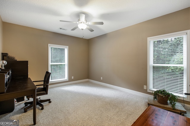 office space featuring carpet, ceiling fan, baseboards, and healthy amount of natural light