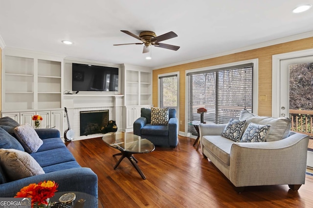living area featuring wood finished floors, a ceiling fan, and recessed lighting