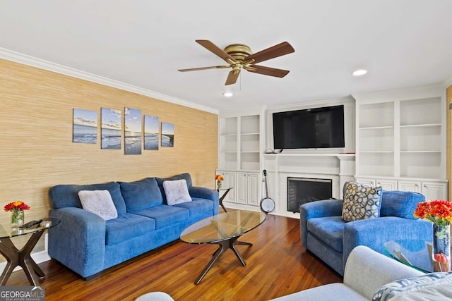 living room with crown molding, a fireplace with flush hearth, a ceiling fan, recessed lighting, and wood finished floors