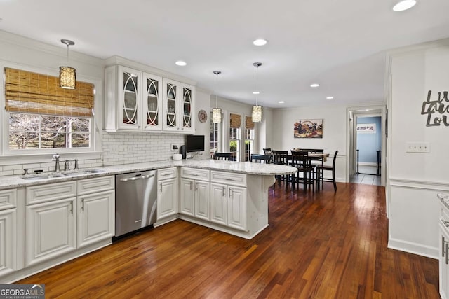 kitchen featuring dark wood-type flooring, a peninsula, white cabinetry, dishwasher, and a sink