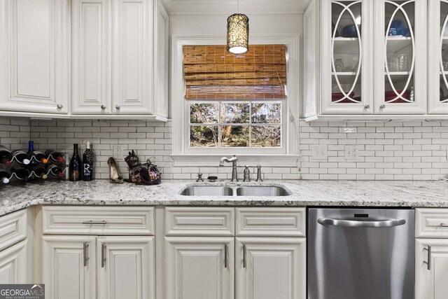 kitchen with a sink, backsplash, stainless steel dishwasher, and white cabinetry