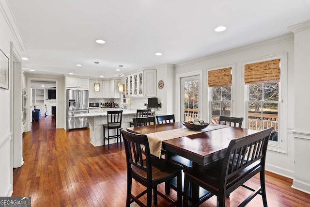 dining room featuring dark wood-style flooring, ornamental molding, and recessed lighting