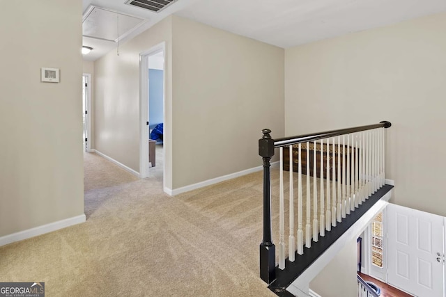 staircase featuring visible vents, attic access, baseboards, and carpet