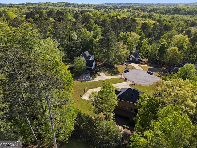birds eye view of property with a forest view