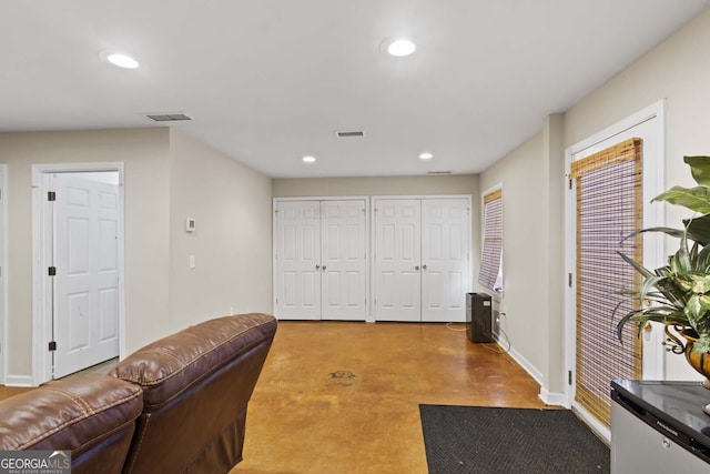 interior space with concrete floors, baseboards, visible vents, and recessed lighting