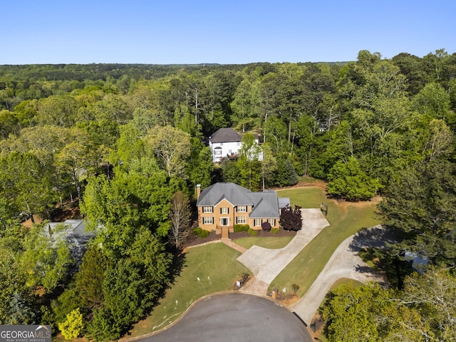 drone / aerial view featuring a forest view
