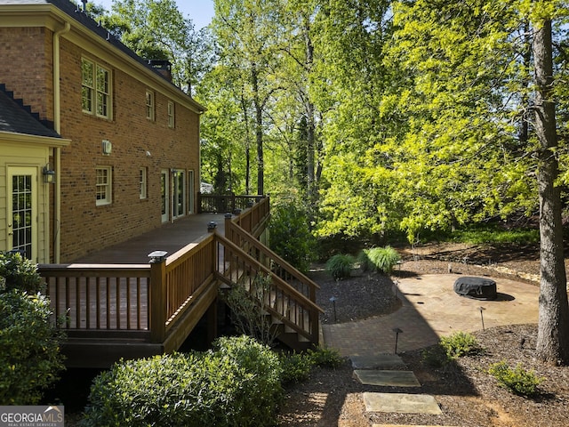 view of yard featuring a wooden deck and an outdoor fire pit