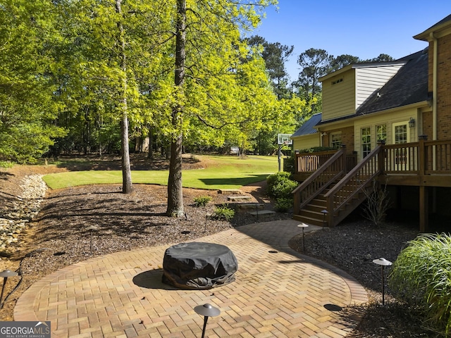 view of patio / terrace featuring a wooden deck and stairs