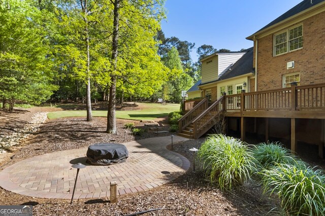 view of yard featuring a patio area, stairway, and a deck