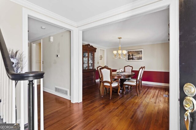dining room featuring visible vents, baseboards, and hardwood / wood-style floors