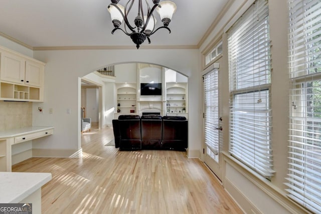 1806 Royal Troon Ct, Duluth, GA 30097 - kitchen with arched walkways, ornamental molding, a chandelier, light wood-type flooring, and light countertops