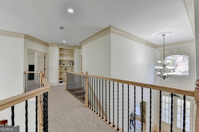 1806 Royal Troon Ct, Duluth, GA 30097 - hallway featuring crown molding, an upstairs landing, a chandelier, built in features, and carpet