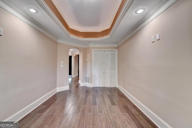 1806 Royal Troon Ct, Duluth, GA 30097 - unfurnished room featuring arched walkways, a raised ceiling, crown molding, and wood finished floors