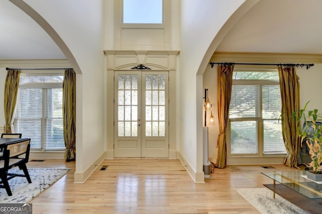 1806 Royal Troon Ct, Duluth, GA 30097 - entrance foyer with arched walkways, light wood finished floors, french doors, and a high ceiling
