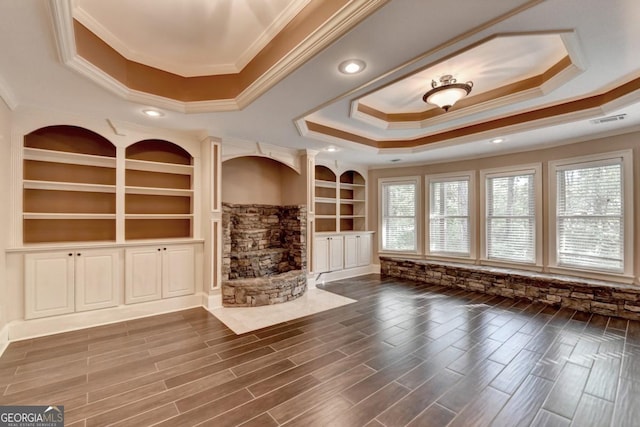 1806 Royal Troon Ct, Duluth, GA 30097 - unfurnished living room featuring a raised ceiling, ornamental molding, built in shelves, wood finished floors, and recessed lighting