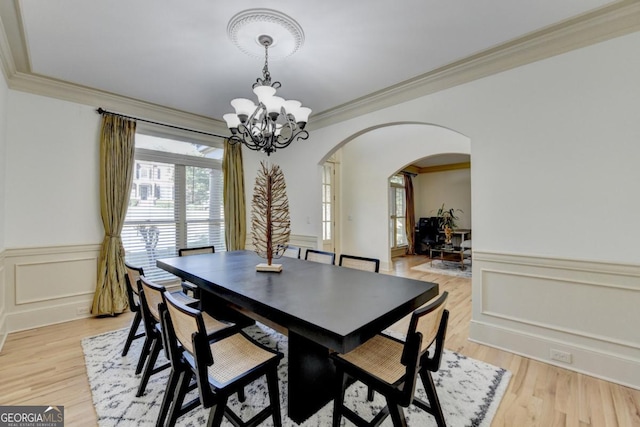 1806 Royal Troon Ct, Duluth, GA 30097 - dining room with arched walkways, a chandelier, crown molding, a wainscoted wall, and a decorative wall