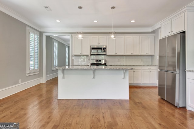 kitchen featuring crown molding, visible vents, white cabinets, and appliances with stainless steel finishes