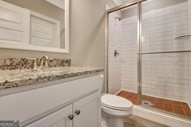 full bath with toilet, a shower stall, and vanity
