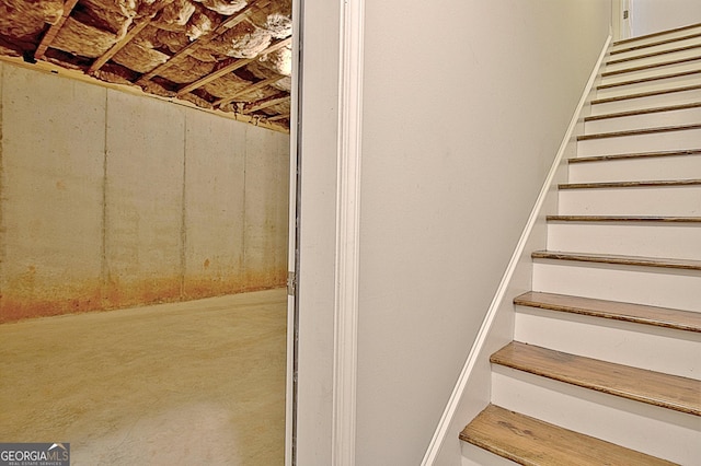 stairs with concrete flooring