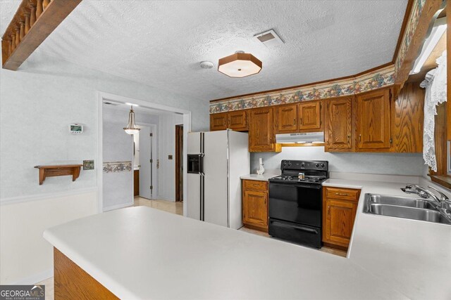 1070 Lovers Lane Rd SE, Calhoun, GA 30701 - kitchen with black range oven, under cabinet range hood, white refrigerator with ice dispenser, a sink, and light countertops