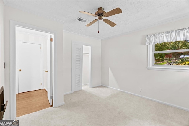 1070 Lovers Lane Rd SE, Calhoun, GA 30701 - unfurnished bedroom with carpet floors, ornamental molding, a textured ceiling, baseboards, and a closet