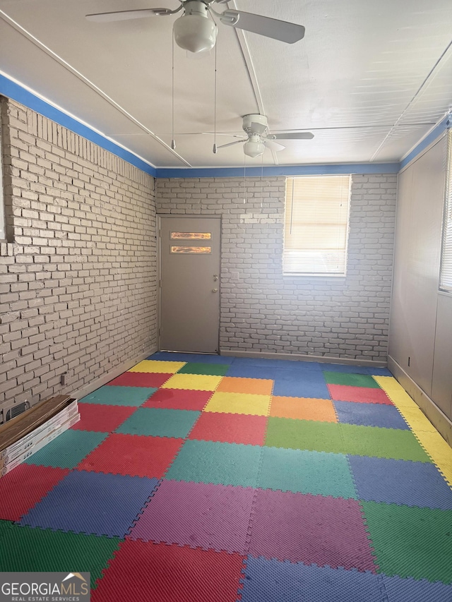 6718 Delta Dr, Riverdale, GA 30274 - interior space with brick wall, tile patterned floors, and a ceiling fan