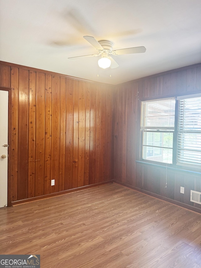 6718 Delta Dr, Riverdale, GA 30274 - unfurnished room featuring wood walls, wood finished floors, ceiling fan, and visible vents
