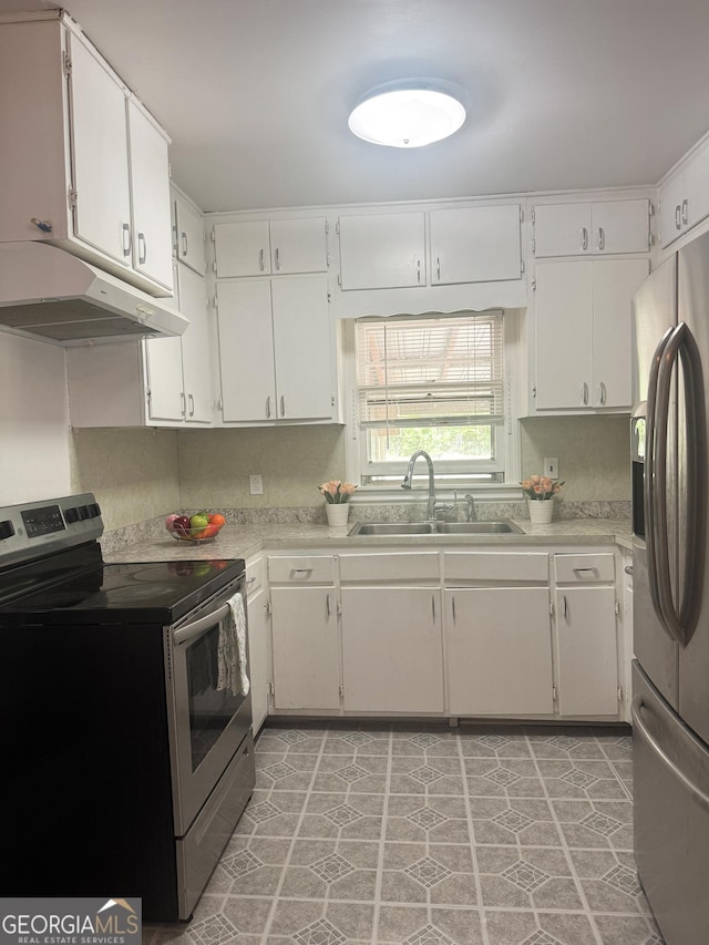 6718 Delta Dr, Riverdale, GA 30274 - kitchen featuring light countertops, white cabinets, under cabinet range hood, stainless steel appliances, and a sink