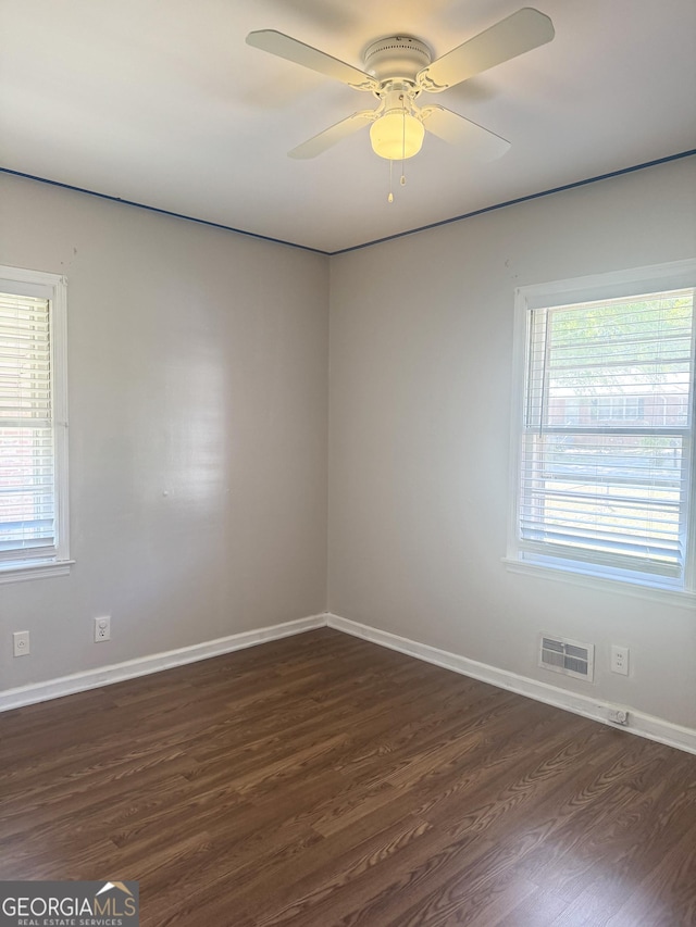 6718 Delta Dr, Riverdale, GA 30274 - empty room with a ceiling fan, a healthy amount of sunlight, dark wood finished floors, and visible vents