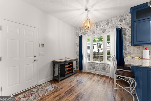 791 Thornwood Cir, Mount Airy, GA 30563 - dining room featuring baseboards, wood finished floors, a chandelier, and a textured ceiling