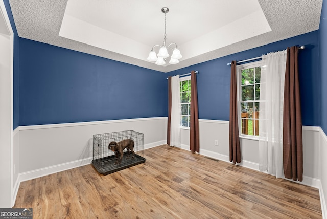 791 Thornwood Cir, Mount Airy, GA 30563 - unfurnished dining area with a raised ceiling, a chandelier, wood finished floors, and baseboards